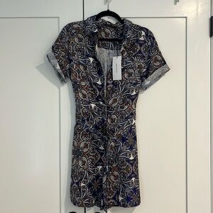 Patterned romper with zipper and button up along with a tie around waist. NEW!!